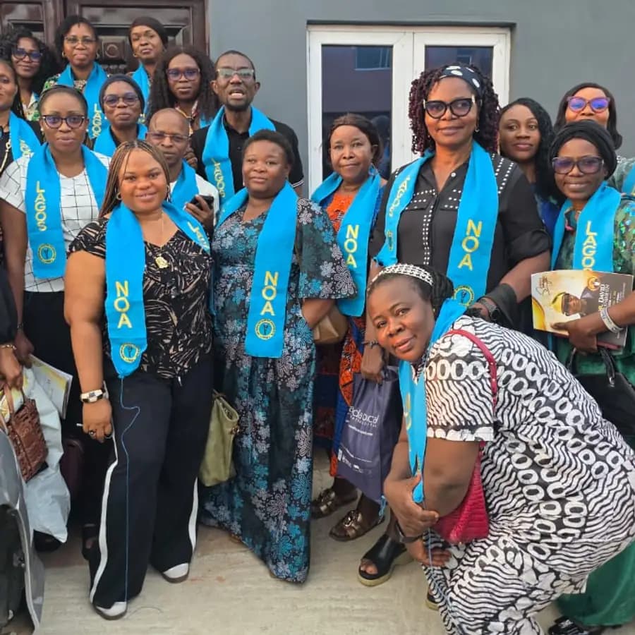 Members of the Lagos chapter in blue NOA Lagos sashes, standing together outside a zonal meeting venue.